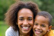 Parent and child smiling outdoors